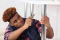 young handsome man assembling furniture Royalty Free Stock Photo