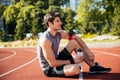 Young handsome man athlete resting at the stadium Royalty Free Stock Photo