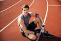 Young handsome man athlete resting at the stadium Royalty Free Stock Photo