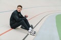 Young handsome man athlete resting at the stadium Royalty Free Stock Photo