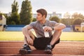Young handsome man athlete resting with water bottle Royalty Free Stock Photo