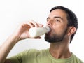 Young Handsome Man with Beard drinking Milk Royalty Free Stock Photo