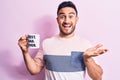 Young handsome man with beard drinking mug of coffee with best dad ever message celebrating achievement with happy smile and