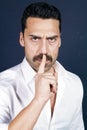Young handsome man with beard and mustache showing hush sign Royalty Free Stock Photo