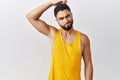 Young handsome man with beard standing over isolated background confuse and wonder about question Royalty Free Stock Photo