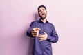 Young handsome man with beard wearing casual shirt laughing at you, pointing finger to the camera with hand over body, shame Royalty Free Stock Photo