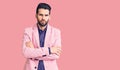 Young handsome man with beard wearing elegant jacket skeptic and nervous, disapproving expression on face with crossed arms Royalty Free Stock Photo