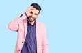 Young handsome man with beard wearing elegant jacket smiling happy doing ok sign with hand on eye looking through fingers Royalty Free Stock Photo