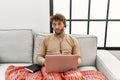 Young handsome man with beard wearing operator headset working from home looking sleepy and tired, exhausted for fatigue and Royalty Free Stock Photo