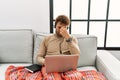 Young handsome man with beard wearing operator headset working from home tired rubbing nose and eyes feeling fatigue and headache Royalty Free Stock Photo