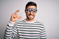Young handsome man with beard wearing optometry glasses over isolated white background smiling and confident gesturing with hand Royalty Free Stock Photo