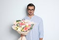 Young handsome man with beautiful flower bouquet Royalty Free Stock Photo