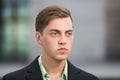 Young handsome man in black blazer on street Royalty Free Stock Photo