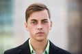 Young handsome man in black blazer walking on street Royalty Free Stock Photo