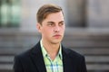 Young handsome man in black blazer walking on street Royalty Free Stock Photo