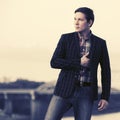 Young handsome man in black checked blazer walking outdoor Royalty Free Stock Photo