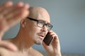 Young handsome man in black glasses is talking on the phone. Big problems, scandal, bad news. Closeup portrait of a man. Manager,