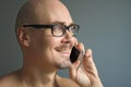 Young handsome man in black glasses is talking on the phone, smiling. Closeup portrait of a man. Manager, office worker, talking Royalty Free Stock Photo