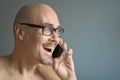 Young handsome man in black glasses is talking on the phone, smiling. Closeup portrait of a man. Manager, office worker, talking Royalty Free Stock Photo