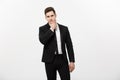 Young handsome man in black suit and glasses looking at copy-space thinking or dreaming isolated over white background Royalty Free Stock Photo