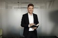 A young, handsome man in a black suit, smiling. Close-up portrait of a businessman. Royalty Free Stock Photo