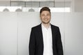 A young, handsome man in a black suit, smiling. Close-up portrait of a businessman. Royalty Free Stock Photo