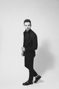 Young handsome man in a black suit, standing, seriously looking Royalty Free Stock Photo