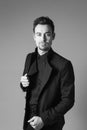 Young handsome man in a black suit, standing, seriously looking Royalty Free Stock Photo