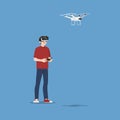 Young handsome man character wear vr glasses controlling a drone multi-copter with camera by wireless remote. The new modern techn Royalty Free Stock Photo