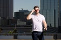 Young handsome man in classik polo t-shirt on the street. Handsome confident stylish hipster model posing outside. Sexy Royalty Free Stock Photo