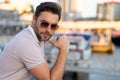 Young handsome man in classik polo t-shirt on the street. Handsome confident stylish hipster model posing outside. Sexy Royalty Free Stock Photo