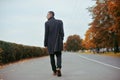 Young handsome man in coat. Fashionable well dressed man posing in stylish coat. Confident and focused boy outdoor at autumn. Royalty Free Stock Photo