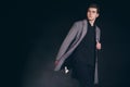 Young handsome man in coat. Portrait of fashionable well dressed man posing in grey stylish coat. Confident and focused boy Royalty Free Stock Photo