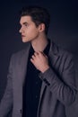 Young handsome man in coat. Portrait of fashionable well dressed man posing in grey stylish coat. Confident and focused boy Royalty Free Stock Photo