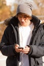 Young handsome man consulting phone outdoors Royalty Free Stock Photo