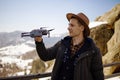 Man controls the flying drones in snowy forest winter. Adventurous winter holiday Royalty Free Stock Photo