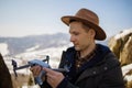 Man controls the flying drones in snowy forest winter. Adventurous winter holiday Royalty Free Stock Photo