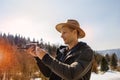 Man controls the flying drones in snowy forest winter. Adventurous winter holiday Royalty Free Stock Photo