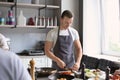 Young handsome man cooking in restaurant kitchen during cooking classes Royalty Free Stock Photo