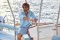 Young handsome man. Cruising on yacht by sea.  Water sport vacation, summer outdoors. Holiday, summer, leisure, lifestyle concept Royalty Free Stock Photo