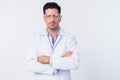 Young handsome man doctor wearing protective glasses with arms crossed Royalty Free Stock Photo