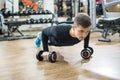 Young handsome man doing push-up exercise with dumbbells. Royalty Free Stock Photo