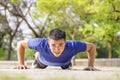 Young handsome man doing push up exercise in the park Royalty Free Stock Photo
