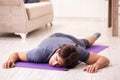 The young handsome man doing sport exercises at home Royalty Free Stock Photo