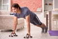 The young handsome man doing sport exercises at home Royalty Free Stock Photo