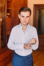 Young handsome man dressing up in hotel room before the formal event Royalty Free Stock Photo