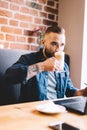 Man drinking coffee, looking at his laptop. Royalty Free Stock Photo