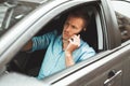 Young handsome man drives unsafely speaking on his smartphone on the run