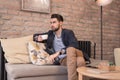 Young handsome man enjoying coffee espresso indoors interior