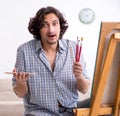 Young handsome man enjoying painting at home Royalty Free Stock Photo